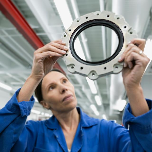 Lubricants for Seals – Female Helicopter Mechanic Examining Disk – Krytox™