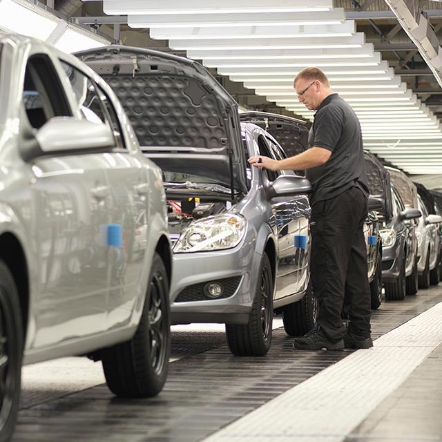 Automotive Industry Lubricants – Man Inspecting Cars on Assembly Line in Manufacturing Plant – Krytox™