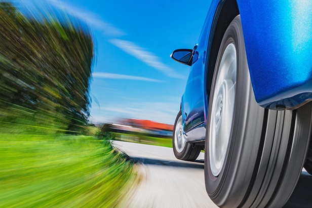 blue car speeding on road