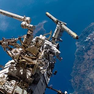 exterior shot of astronauts working on the space station