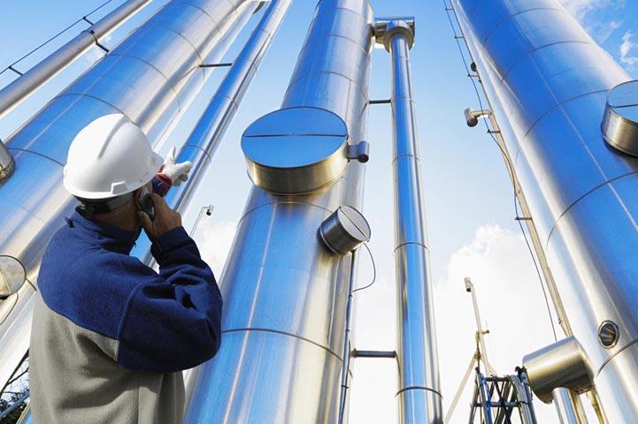 worker pointing at towers while talking on the phone